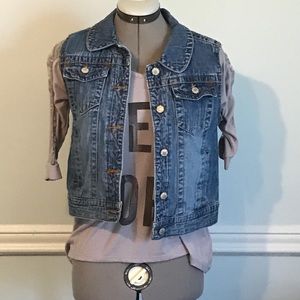 Denim vest with gem and art work on back.